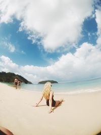 People on beach against sky