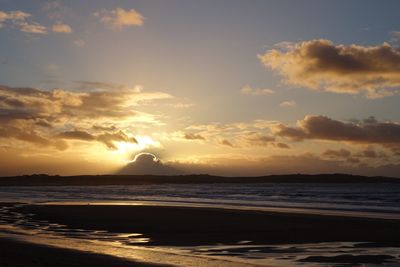 Scenic view of beach against sky during sunset