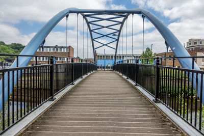 Bridge over footbridge against sky