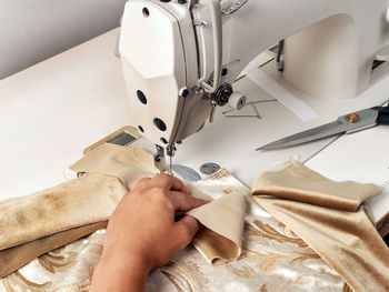 High angle view of person working on sewing machine