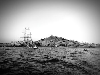 Ship moored in sea against clear sky