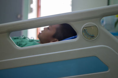 Boy sleeping on bed in hospital