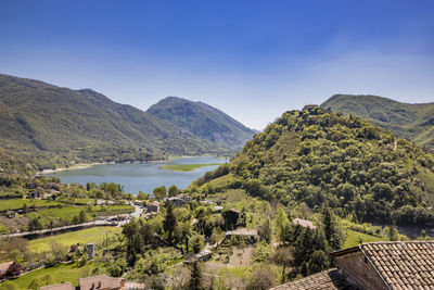Scenic view of sea and mountains against sky