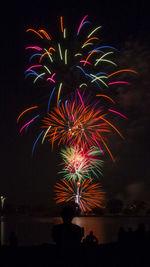 Low angle view of firework display at night