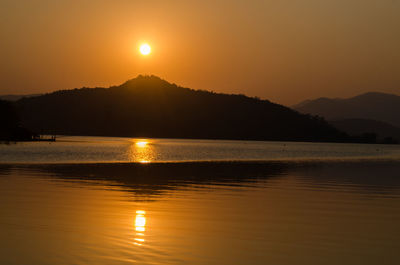 Sunset or sunrise over river and mountain in kanchanaburi province, thailand.