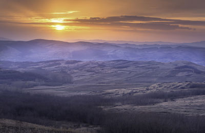 Scenic view of landscape against sky during sunset