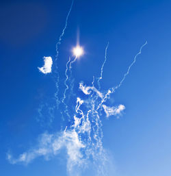 Low angle view of firework display against sky