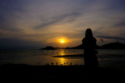 Silhouette people on beach against sky during sunset at thailand single travel new normal concept