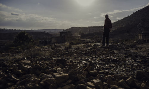 Senior man standing on landscape against sky