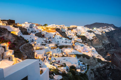 High angle view of town against clear blue sky