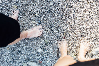 Low section of friends standing at shore