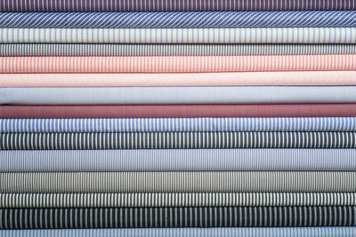 Close-up of multi colored fabrics stacked in row