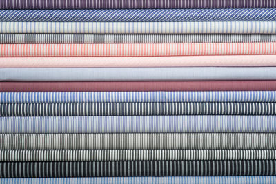 Close-up of multi colored fabrics stacked in row