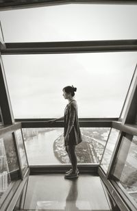 Full length of woman standing by railing