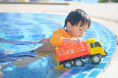 Portrait of boy playing in pool