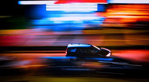 Blurred motion of car on road at night