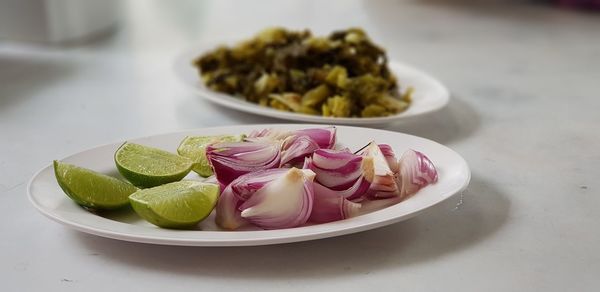 Close-up of sliced onion and limes in plate