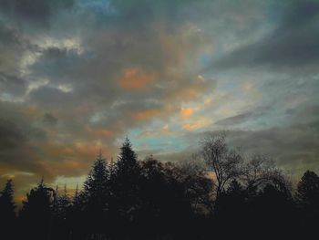 Low angle view of silhouette trees against sky at sunset