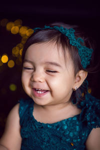 Girl in blue dress in studio with gold sequins and garland