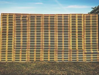 Close-up of metal structure on field against sky