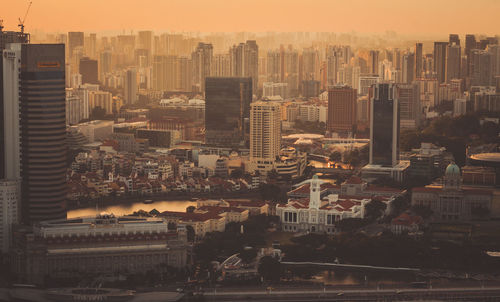 High angle view of buildings in city against sky during sunset