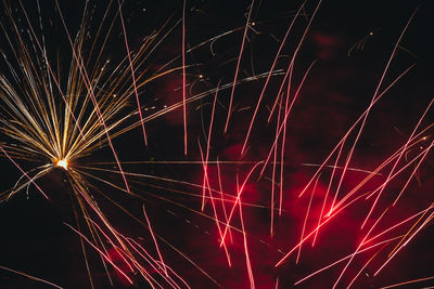 Low angle view of firework display at night