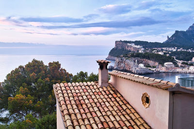 High angle view of townscape by sea against sky