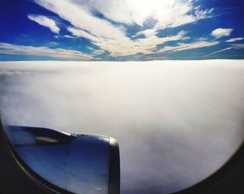 Aerial view of cloudscape over airplane wing