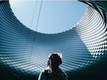 Low angle view of woman on modern building