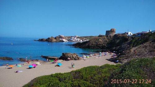 Scenic view of beach against clear blue sky