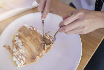 High angle view of person preparing food in plate