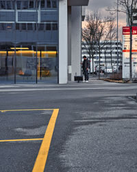 Man walking on street against buildings in city