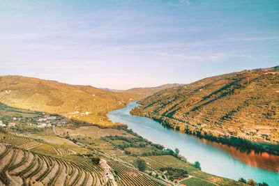 High angle view of river amidst mountains against sky