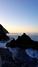 Scenic view of sea against clear sky during sunset