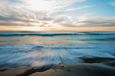 Scenic view of sea against cloudy sky