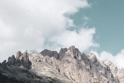 Low angle view of rocky mountains against sky