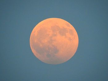 Low angle view of moon against clear blue sky