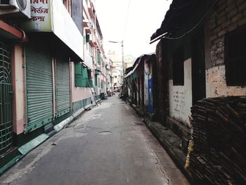 Empty alley amidst buildings in city