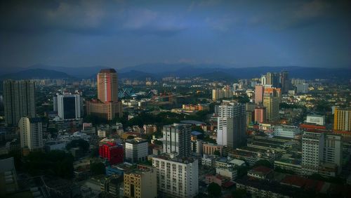 Cityscape against cloudy sky