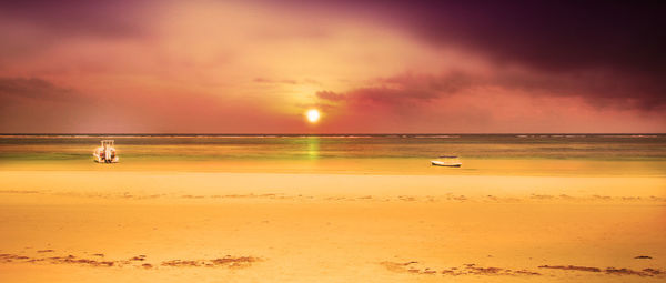 Scenic view of beach against sky during sunset