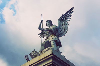 Low angle view of statue against sky