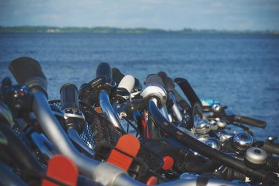 Close-up of bicycle handles against river