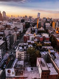 High angle view of city buildings against sky during sunset