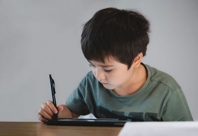 Portrait of boy holding table