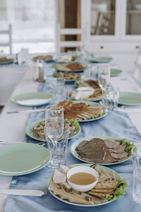 Beautifully laid tables with glasses and appliances at morning in restaurant. empty glasses