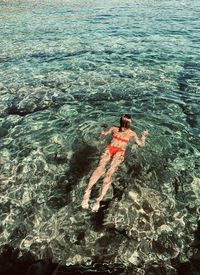 High angle view of woman swimming in sea