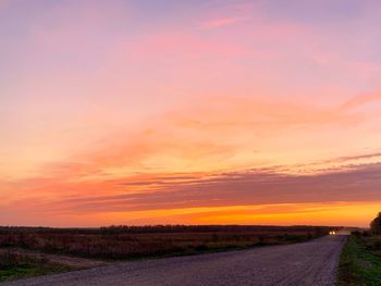 Scenic view of road against sky during sunset