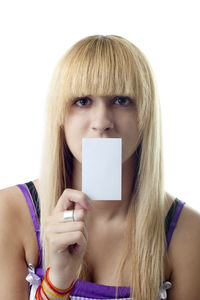 Portrait of a young woman wearing hat against white background