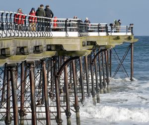 Railing in sea against sky