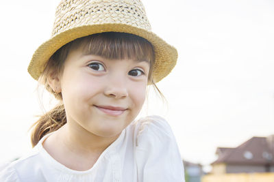 Close-up of young woman wearing hat